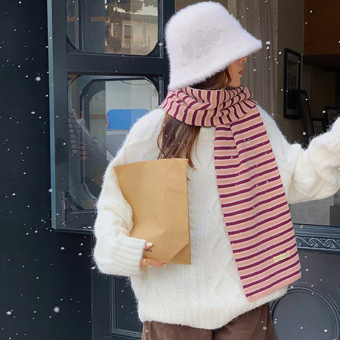 Model wearing a striped knit scarf in pink, easy for weekend styling and gifting.