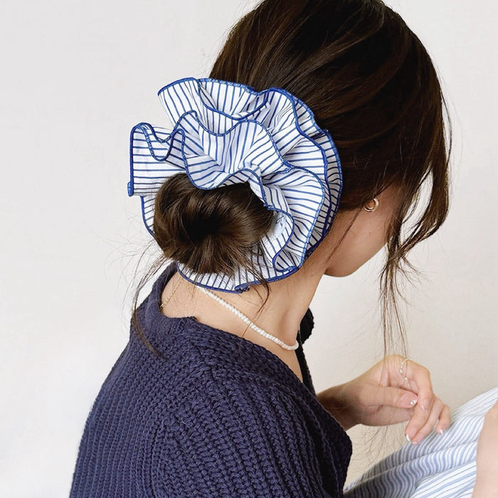 Model wearing a  Striped Layered Scrunchie in blue and white, ideal for everyday outfits and office looks.
