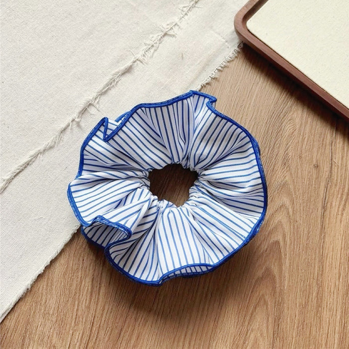 Angled view of Striped Layered Scrunchie in white and blue, ideal for quick updos and ponytails.