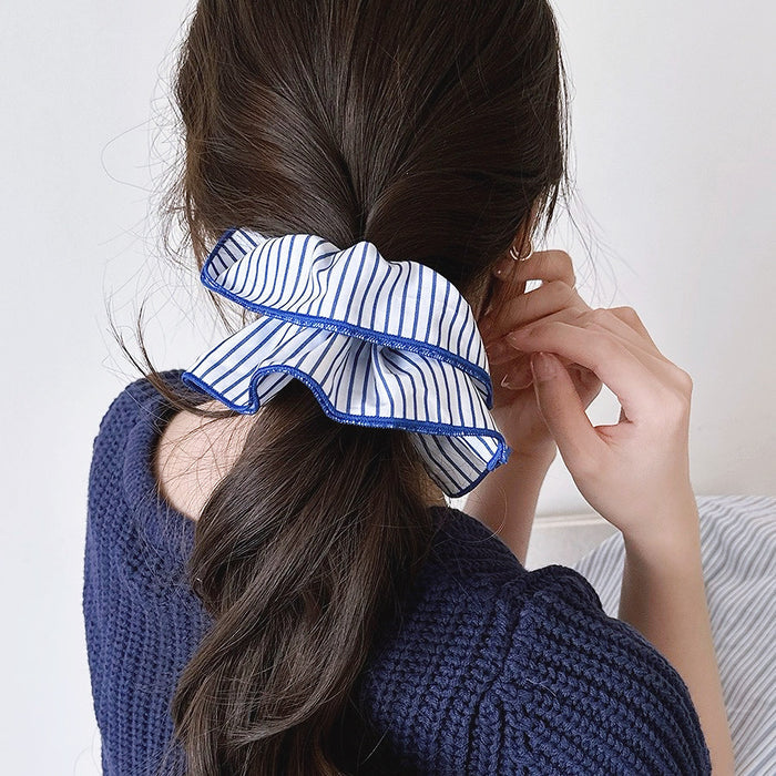 Model wearing a blue Striped Layered Scrunchie, easy for workdays and special occasions.