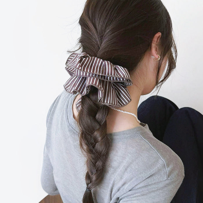 Model wearing a Striped Layered Scrunchie in brown, ideal for quick updos and ponytails.