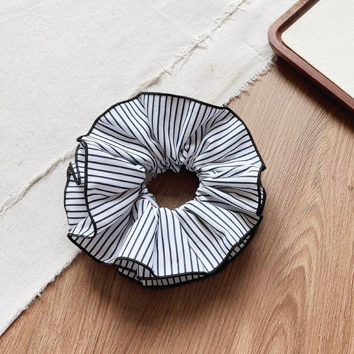 Angled view of Striped Layered Scrunchie in white and black, great for everyday styling and gifting.