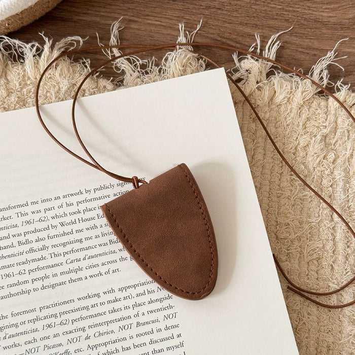 Close-up of Suede Arrow Eyeglass Holder Necklace in Brown, easy to style.