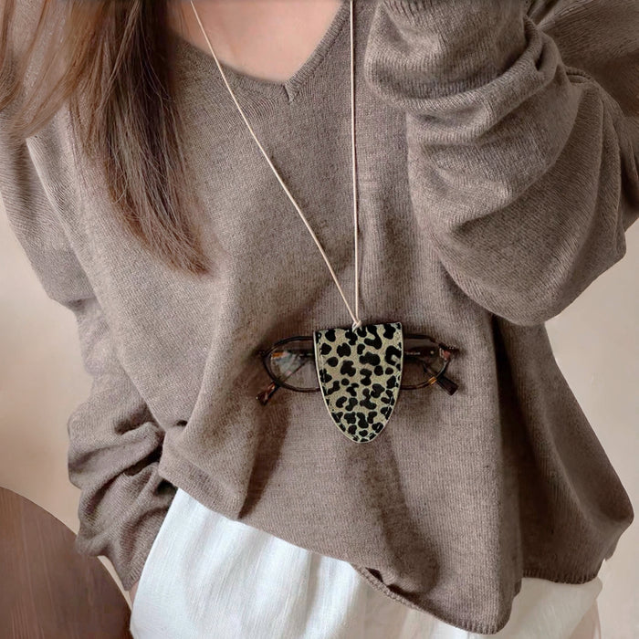 Model wearing Suede Arrow Eyeglass Holder Necklace in Khaki Leopard.
