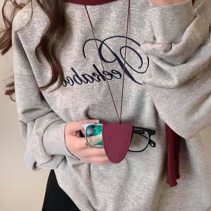 Model wearing Suede Arrow Eyeglass Holder Necklace in Claret, easy to style.