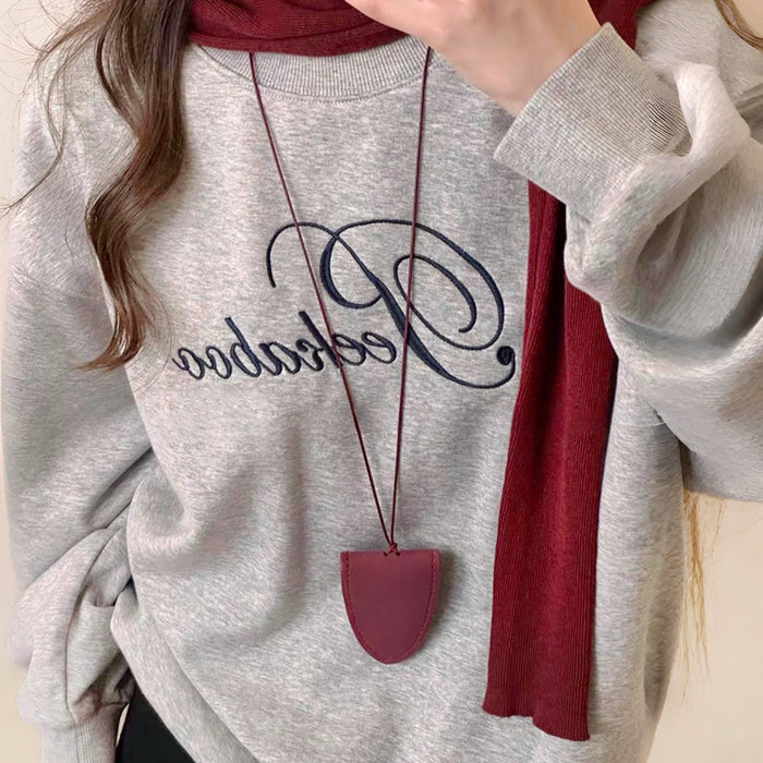 Model styling Suede Arrow Eyeglass Holder Necklace in Claret.