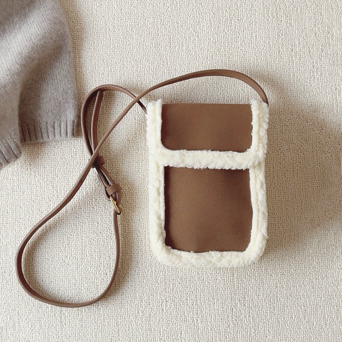 Front view of Brown vegan suede crossbody bag with plush white trim and a long strap, great for everyday carry.
