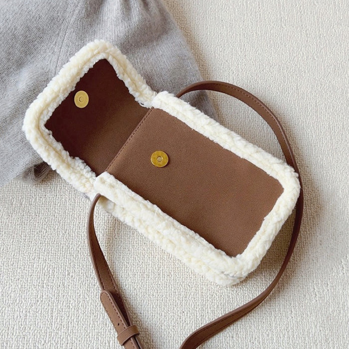Angled view of Brown vegan suede crossbody bag with plush cream trim and magnetic flap closure Suede Crossbody Bag.