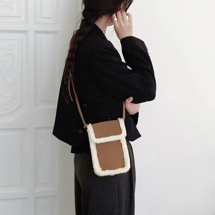 Model carrying a brown Suede Crossbody Bag With Plush Trim as crossbody, ideal for city walks and gifting.