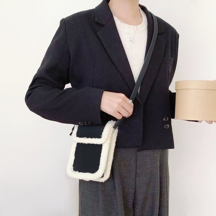 Model carrying a black Suede Crossbody Bag With Plush Trim as crossbody , easy for commuting and weekends.