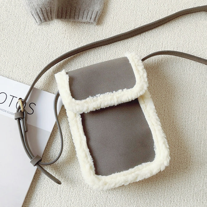 Angled view of Suede Crossbody Bag With Plush Trim in gray, great for everyday carry and travel.