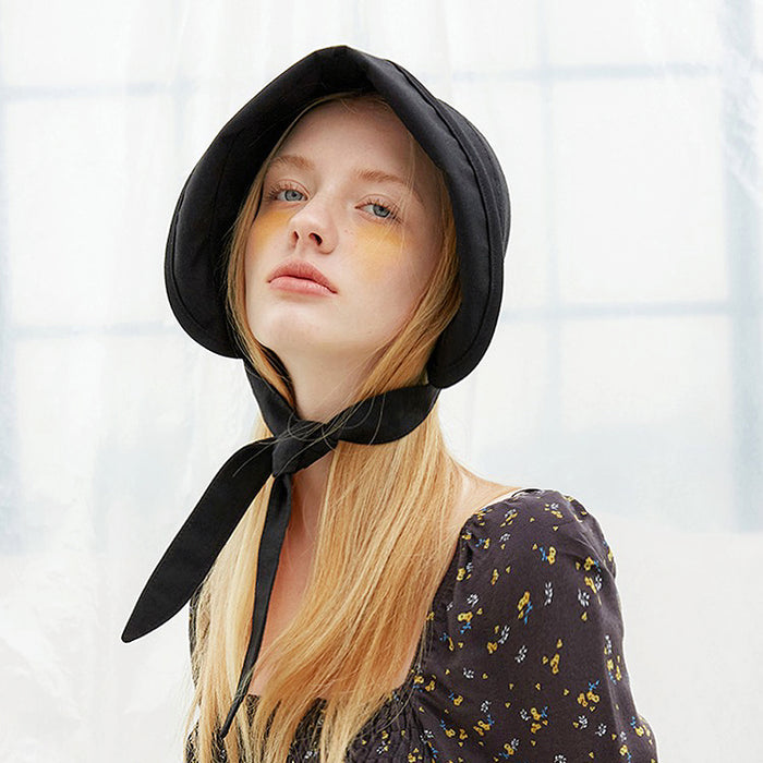 Side profile of the black sun shield hat showing the brim's protective coverage.