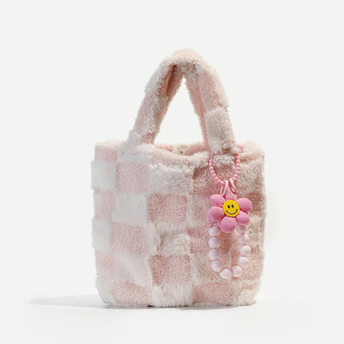Pink Sunny Bloom Bag Charm hanging on a pink checkered handbag, great for cute looks and travel days.