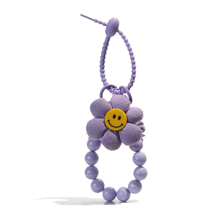 Folded view of Sunny Bloom Bag Charm in purple, easy to attach to bags and phones.