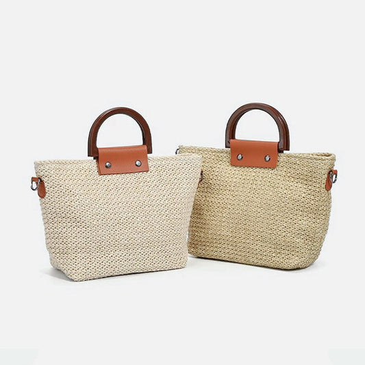 Two raffia straw woven bags, one light beige and one natural, with dark wood grab handles and brown leatherette.