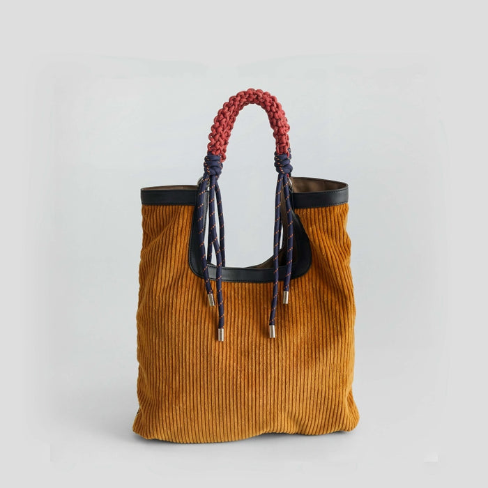 Front view of the corduroy tote bag featuring unique colorful braided rope handles, clean background.