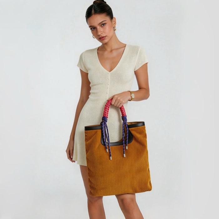 Model carrying the large capacity corduroy tote bag, showcasing an elegant casual style.