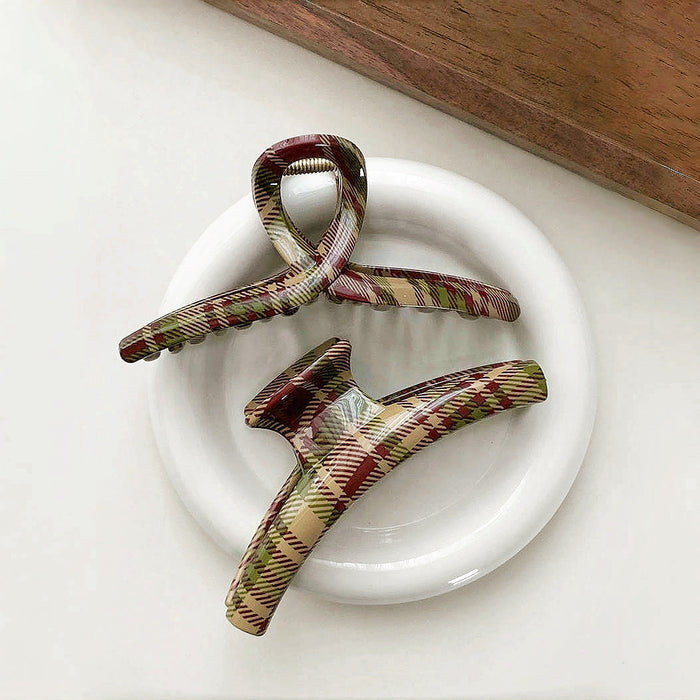 Front view of  two Acrylic tartan hair claw in red, green, and beige plaid.
