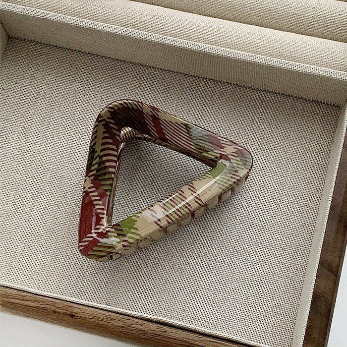 Angled view of triangle Tartan Elegance Hair Claw, easy for workdays and special occasions.