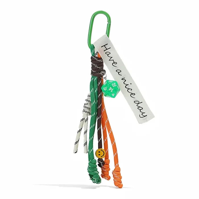 Flat lay of Tassel Strings Bag Charm in green, great for everyday styling and gifting.
