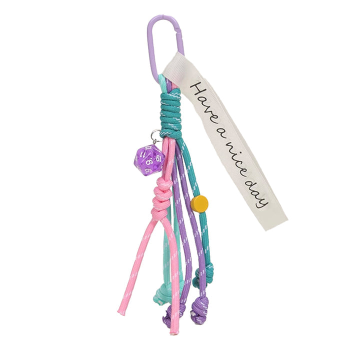 Folded view of Tassel Strings Bag Charm in turquoise , easy to attach to bags and phones.