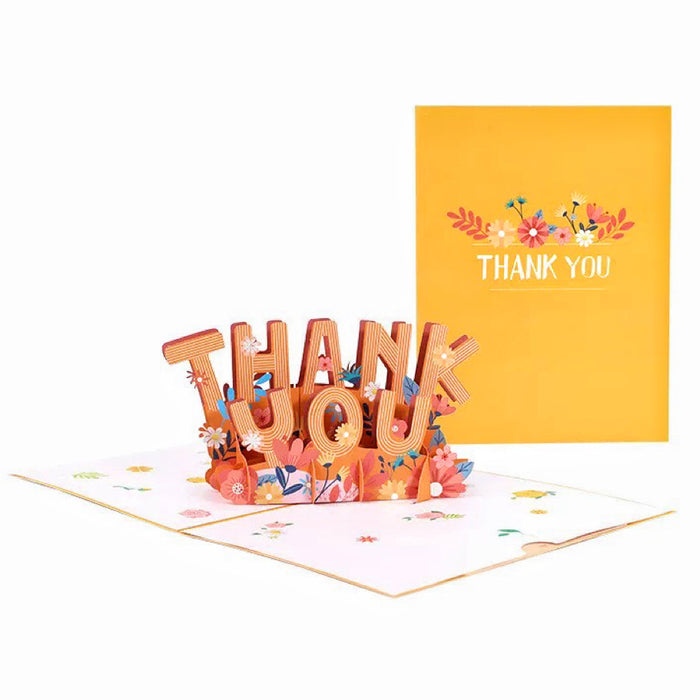 Front view of Yellow paper pop-up Thank You card with colorful floral designs, open to reveal 3D text .