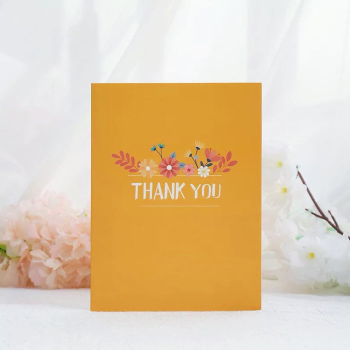 Front view of a thank-you card, featuring a yellow cover printed with the words Thank You.