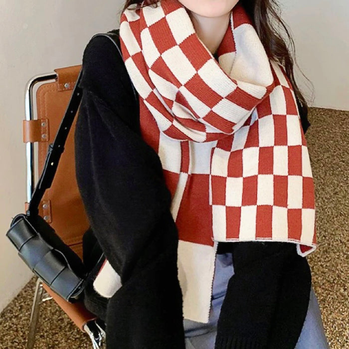 Model wearing Thick wool scarf with a red and white checkered pattern, great for office.