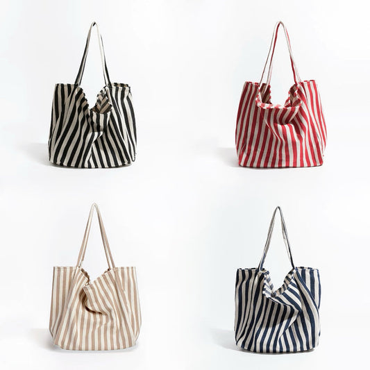 Four thin stripe canvas tote bags: black, red, khaki, and navy blue, all with shoulder straps and open tops.