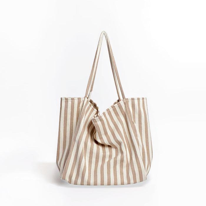 Front view of khaki and white striped canvas tote, minimalist aesthetic ideal for summer vacations.