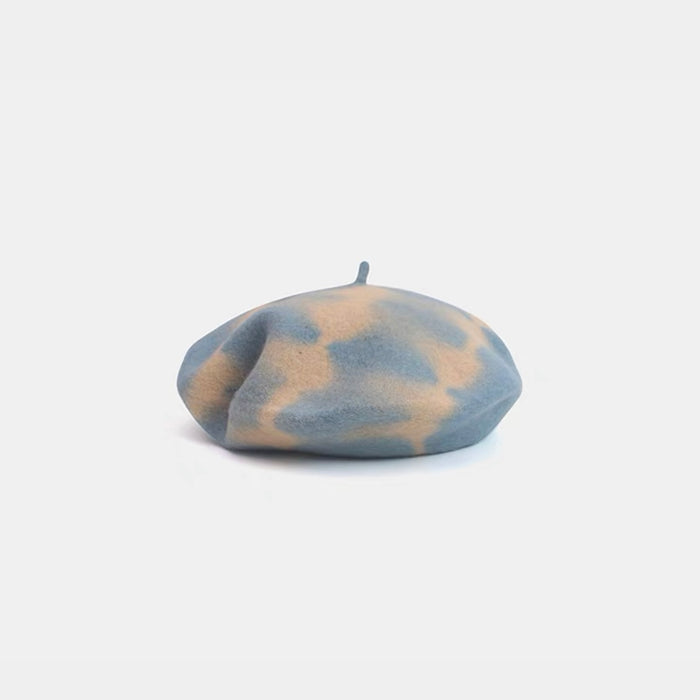 Light blue and beige tie-dye wool beret displayed on a white background.