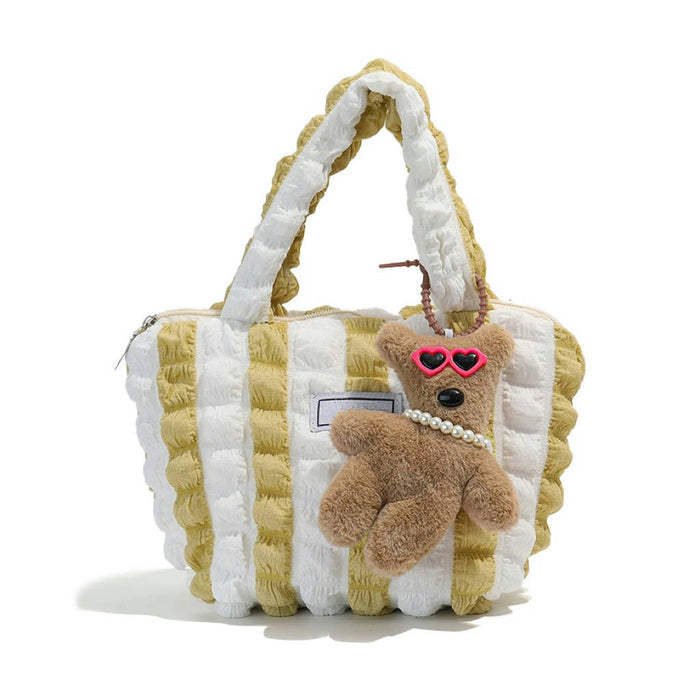 Pink Tilted Sunglasses Bear Bag Charm hanging on a striped bag.