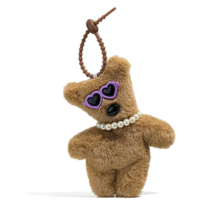 Close-up of Tilted Sunglasses Bear Bag Charm in purple, ideal for travel and daily use.