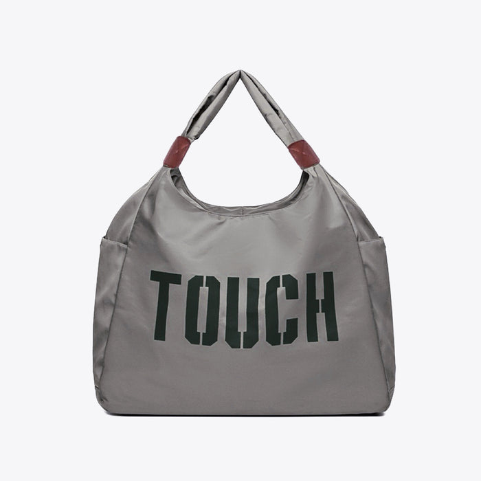 Flat lay of Touch Nylon Weekend Bag in gray, easy for commuting and weekends.