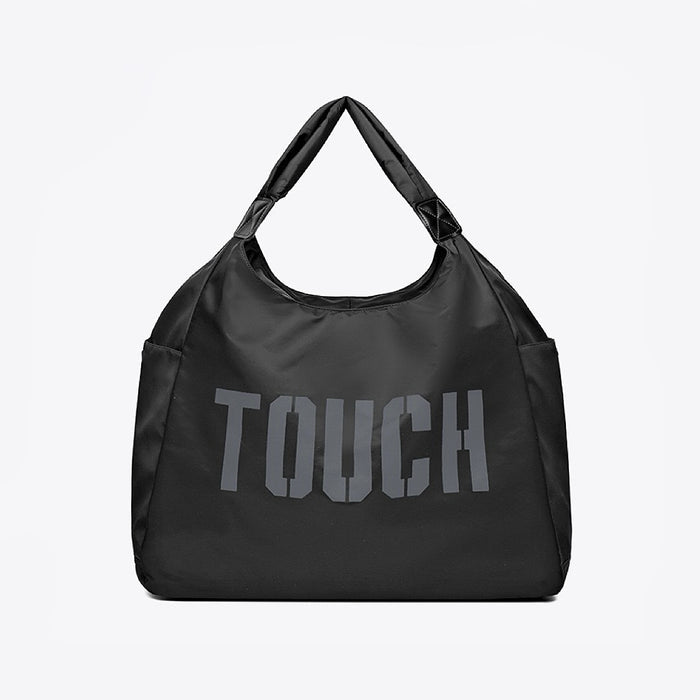 Flat lay of Touch Nylon Weekend Bag in black, great for everyday carry and travel.