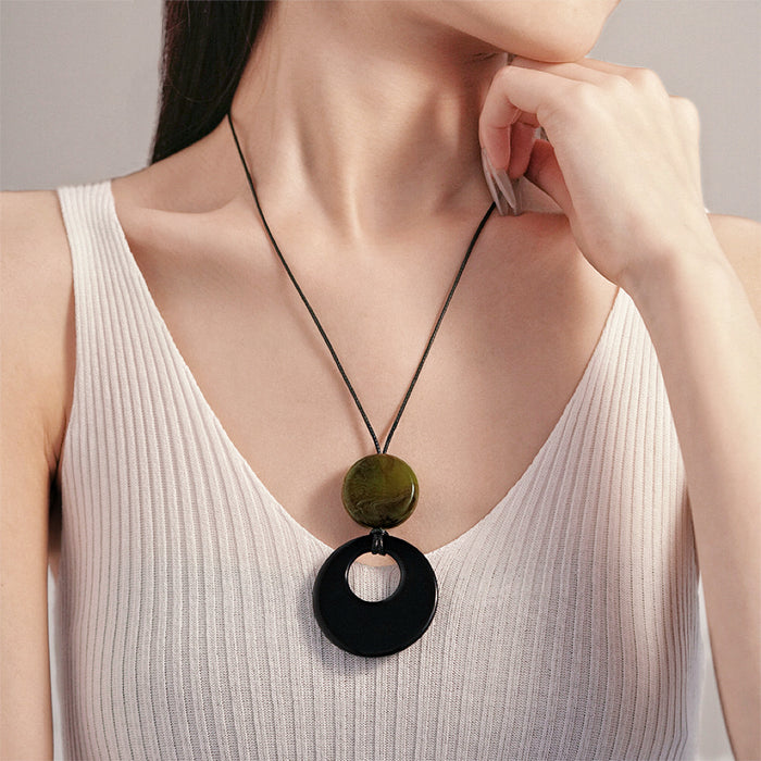 Model wearing a Twilight Loop Necklace in Black Green, ideal for date nights.