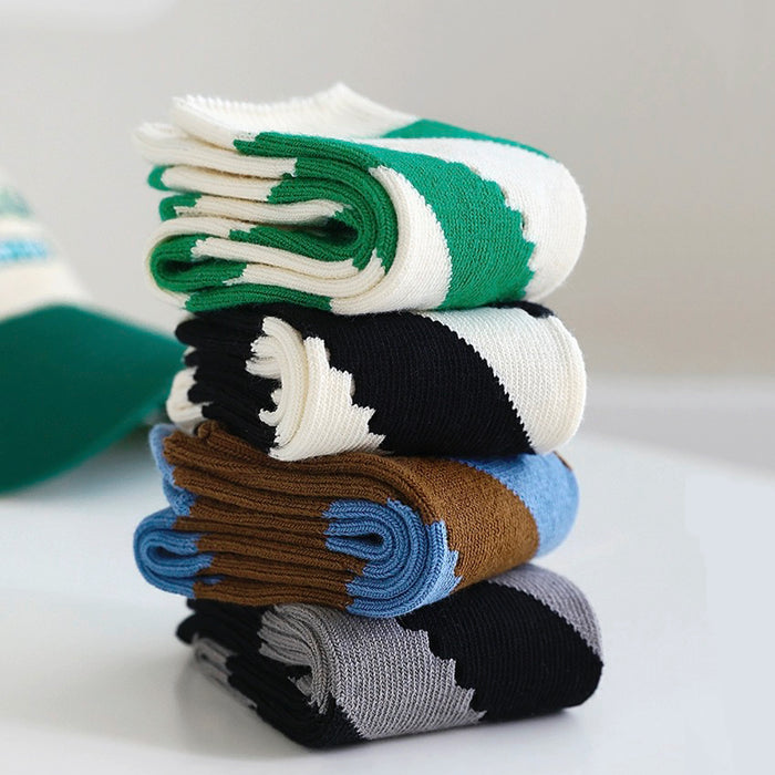 Angled view of Stacked twill cutout socks in green, black, brown, and gray with white and blue accents.