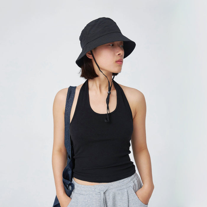 Model wearing black nylon ultralight bucket hat, features rapid moisture-wicking technology and windproof cord.