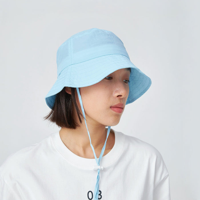 Model wearing light blue Ultralight Quick Dry Bucket Hat, perfect for water sports and intensive summer activities.