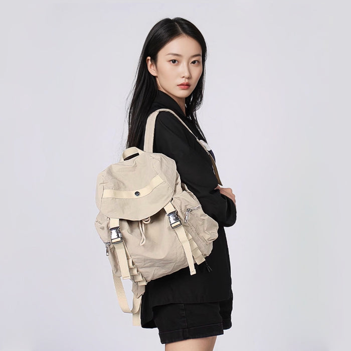 Model carrying a khaki Ultralight Urban Daily Backpack, casual outdoor lifestyle view.