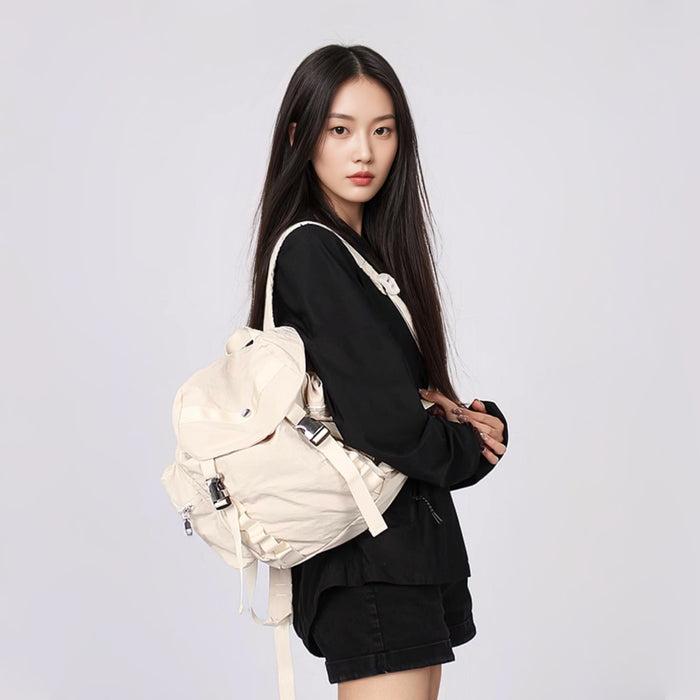 Model carrying a beige polyester backbag on the shoulder, easy for commuting and weekends.
