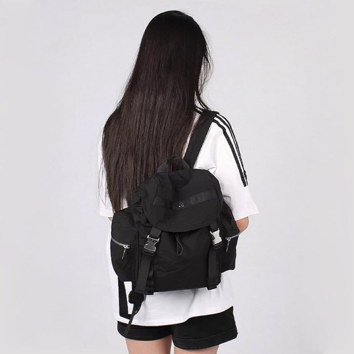 Model carrying a black ultralight backpack on the shoulder, great for daily carry and travel.
