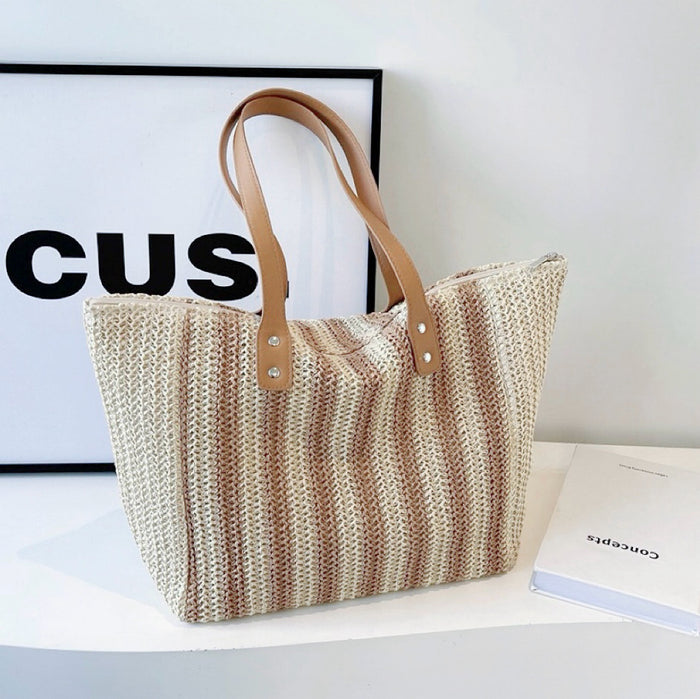 Folded view of Vertical Striped Straw Tote Bag in khaki, easy for commuting and weekends.