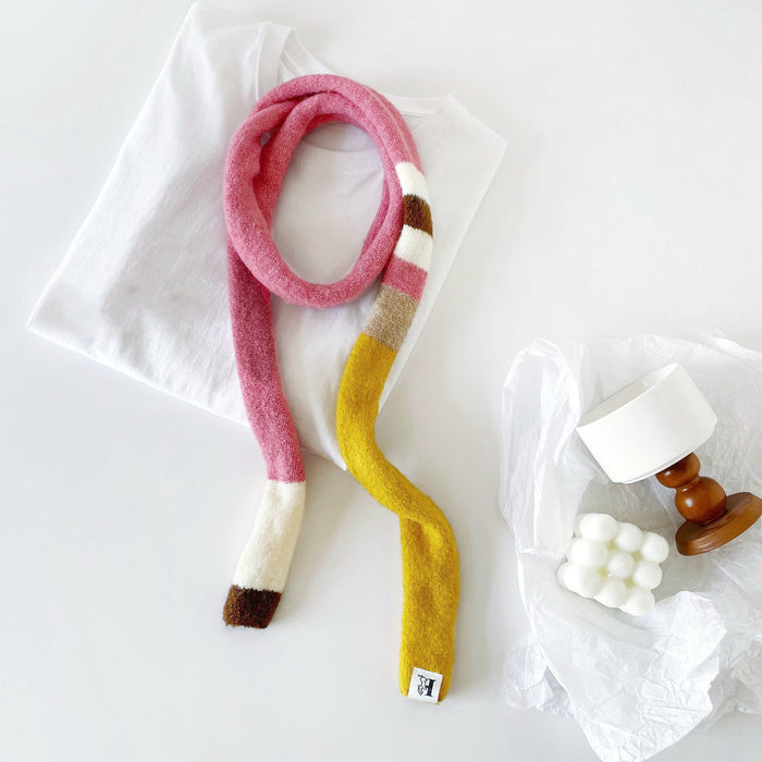 Model wearing a polyester scarf in pink and yellow, great for office layering and commuting.