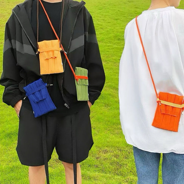 One model carrying an orange mini bag as crossbody, and the other model carrying blue, yellow and green bags.