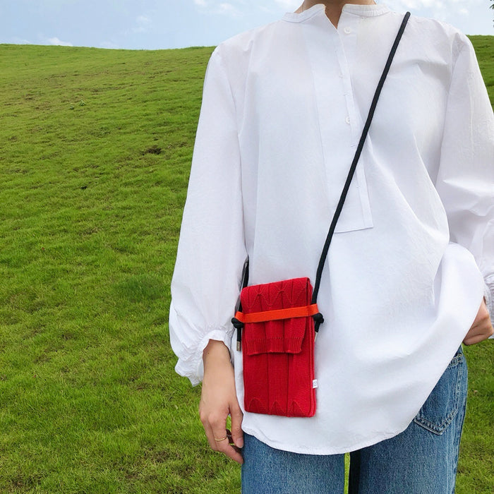 Model carrying a red polyester mini bag on the shoulder, great for daily carry and travel.