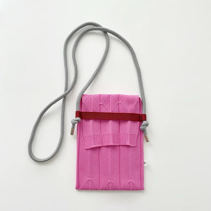 Folded view of Vivid Knit Pleat Mini Bag in pink, easy for commuting and weekends.