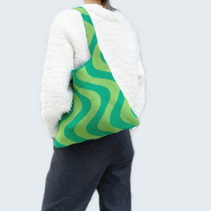Model carrying a green Wave Pattern Knitted Bag on shoulder  , easy for commuting and weekends.