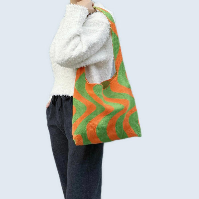 Model carrying an orange green Wave Pattern Knitted Bag on shoulder , ideal for city walks and gifting.