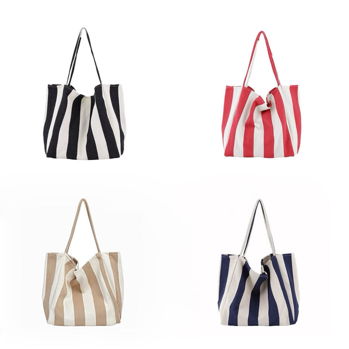 Four wide stripe canvas tote bags in black, red, khaki, and navy blue with shoulder straps and open tops.